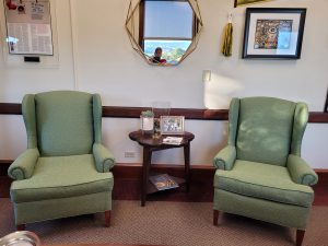 Two green upholstered chairs.
