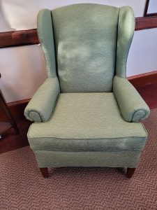 Front view of a green upholstered chair.