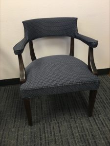 A dark grey upholstered chair.