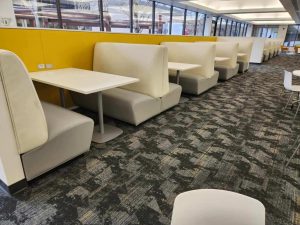 A row of white upholstered benches.