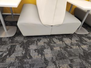 Close-up of two white upholstered benches.