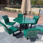 Green metal picnic table with green metal chairs.