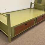 Olive green metal military bed.