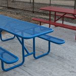 Blue and red metal picnic tables.